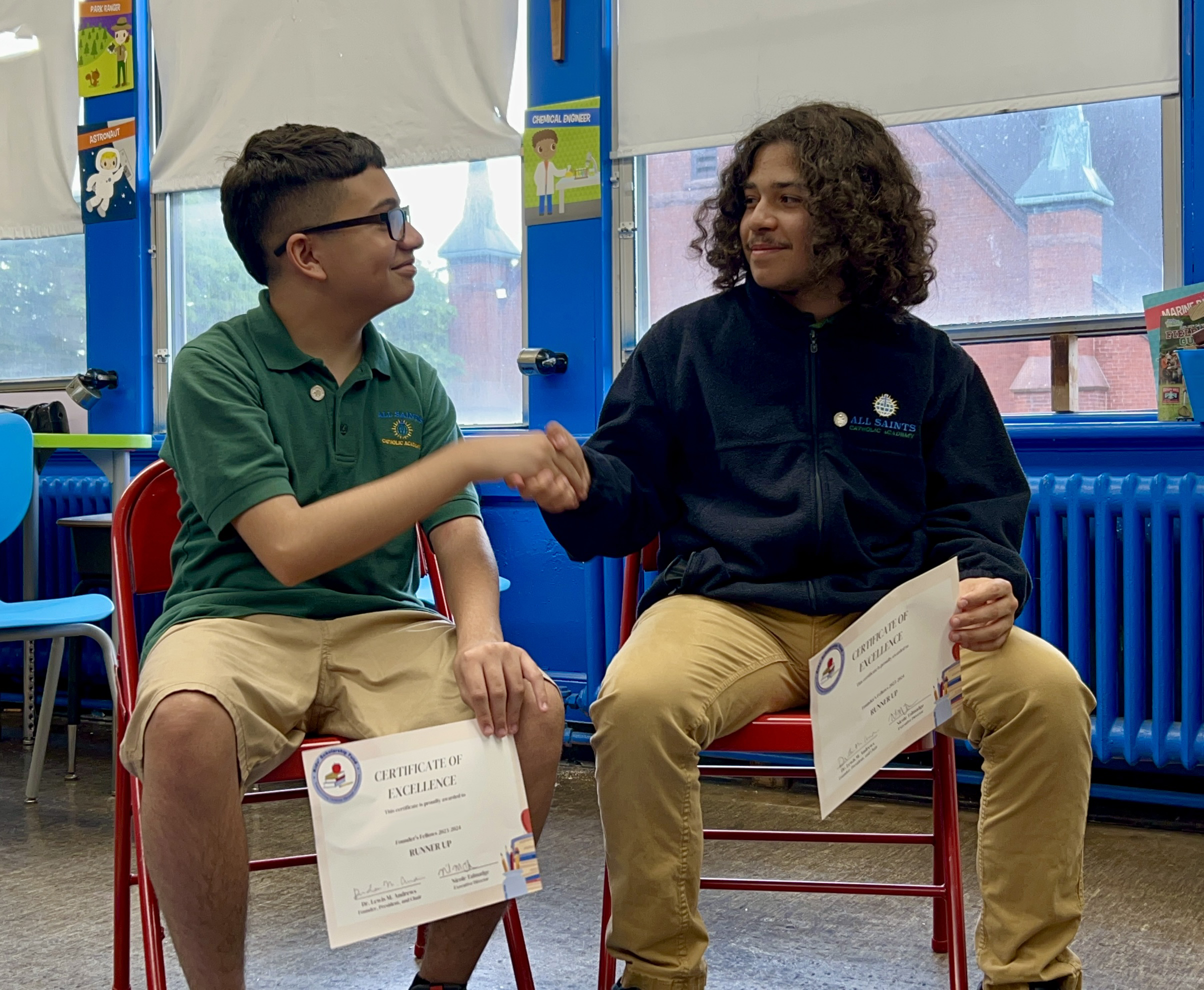 Scholarship recipients Joshua and Noah shaking hands