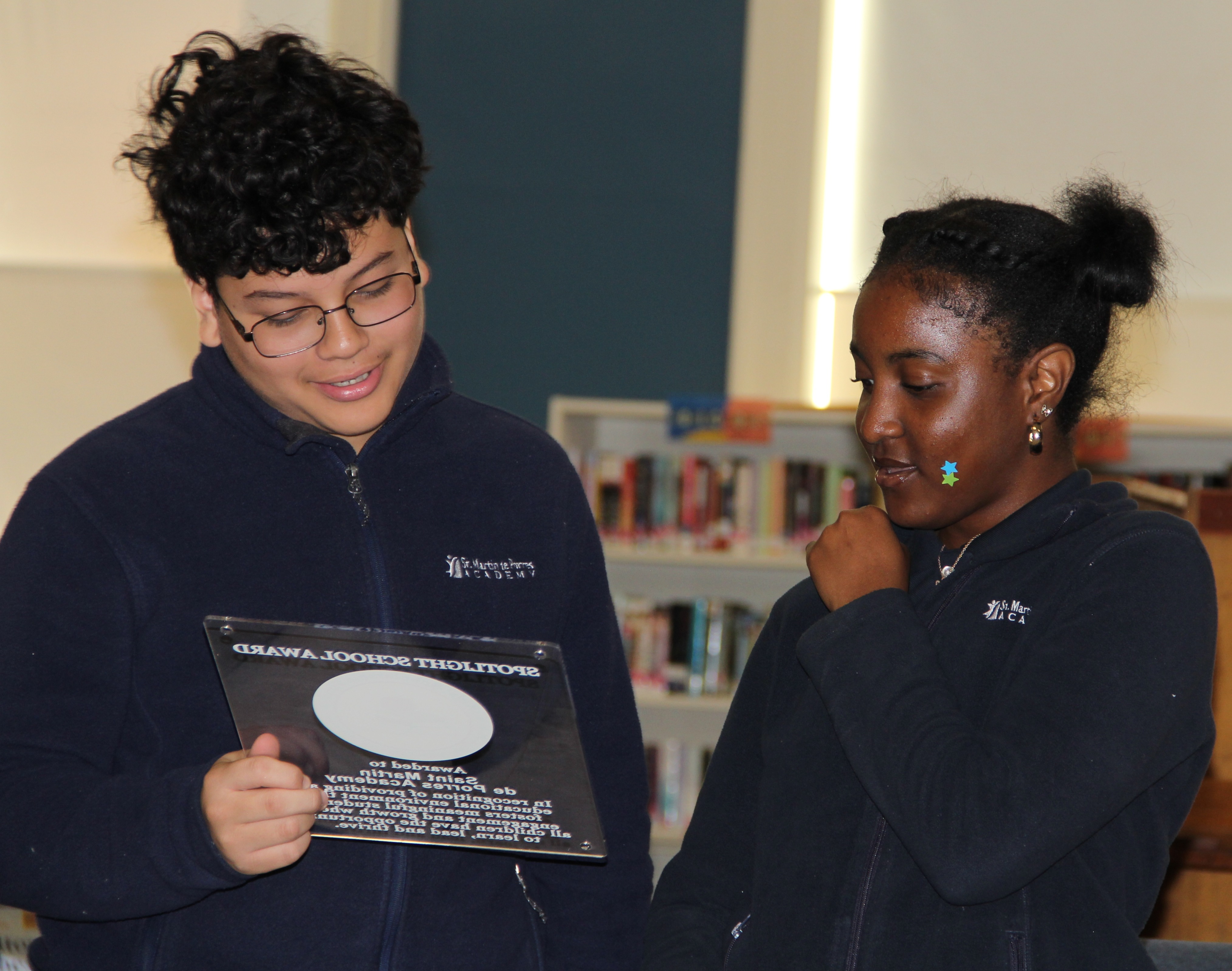 Students holding spotlight school award